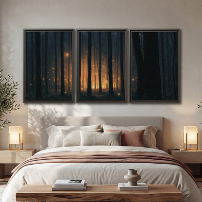 A warm amber glow shining between closely spaced dark forest trunks 3 piece framed canvas wall art displayed in a bedroom
