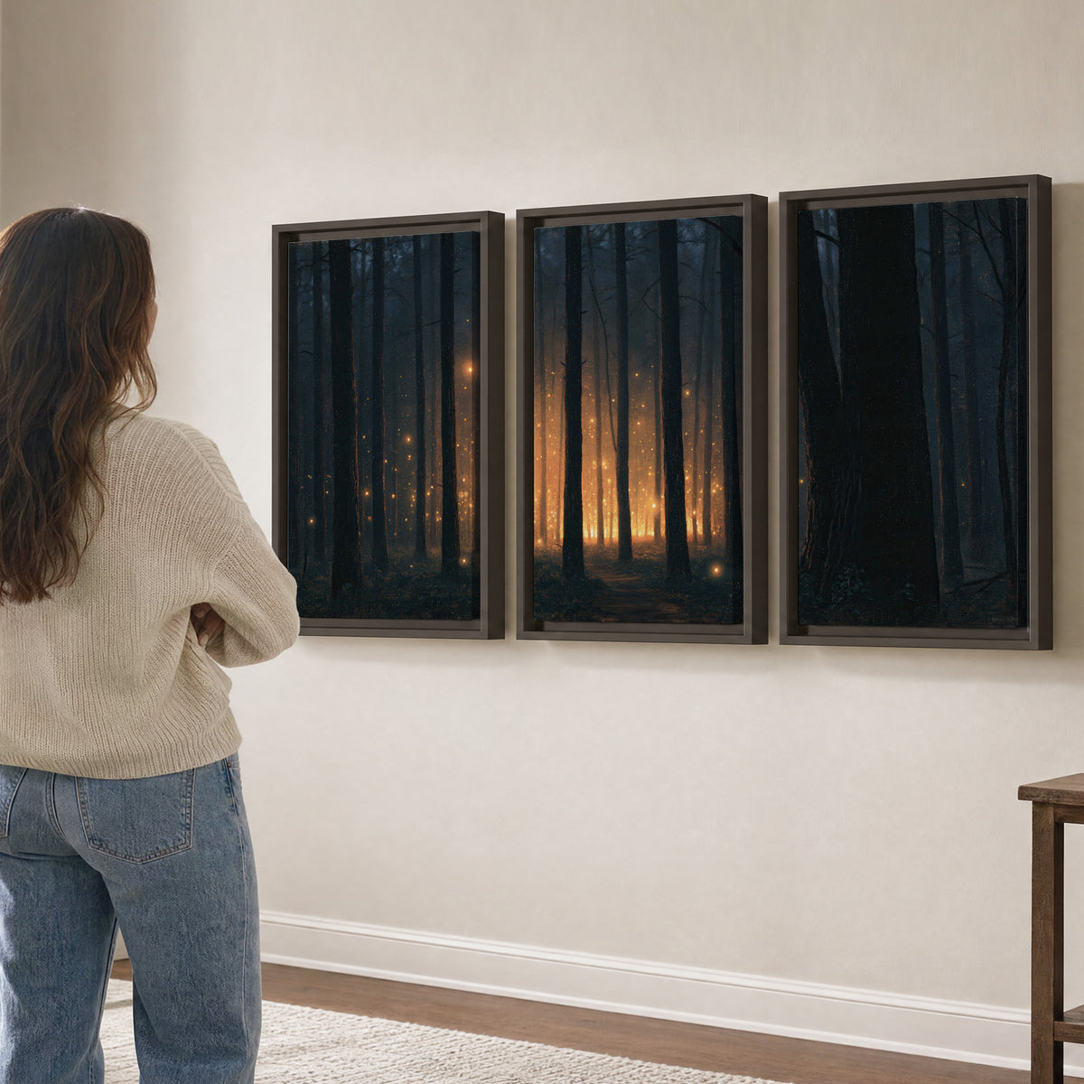 A warm amber glow shining between closely spaced dark forest trunks 3 piece framed canvas wall art three panel arrangement on a wall