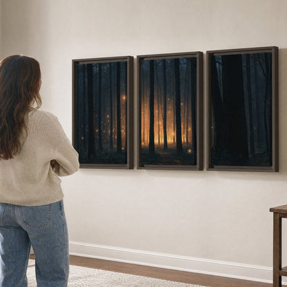 A warm amber glow shining between closely spaced dark forest trunks 3 piece framed canvas wall art three panel arrangement on a wall