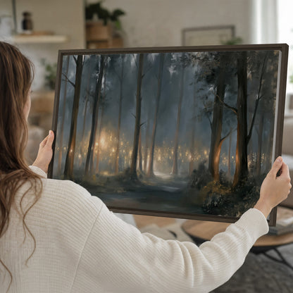 Soft warm light filtering through tall trees in a cool mist-covered forest single framed canvas wall art held in hands