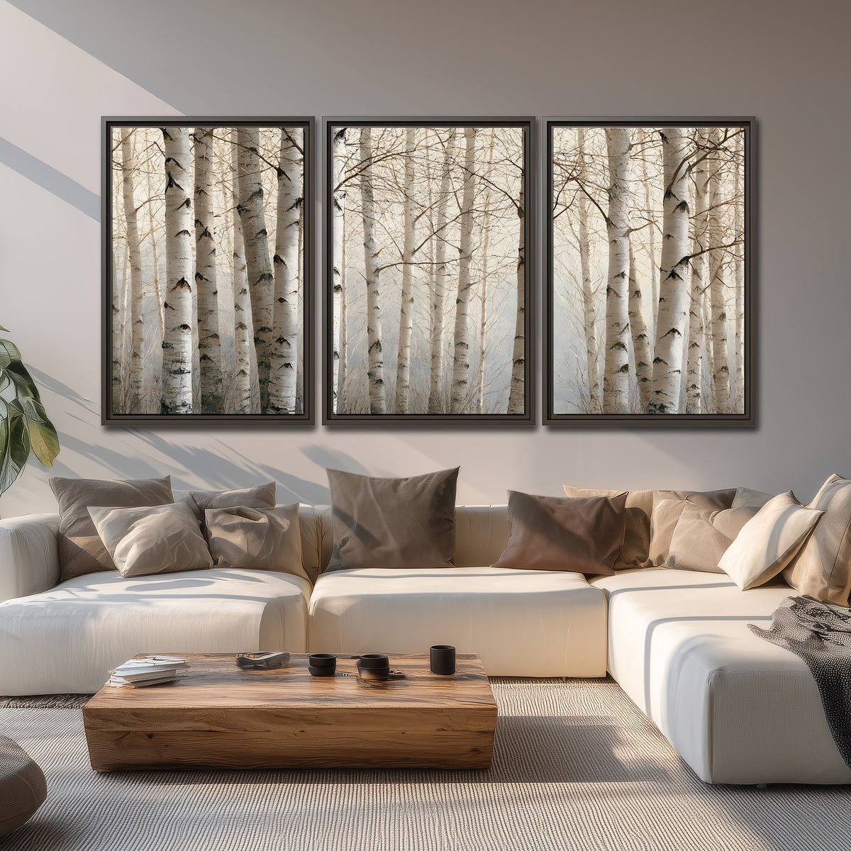 Pale birch trunks and delicate bare branches in a soft neutral woodland 3 piece framed canvas wall art displayed in a living room