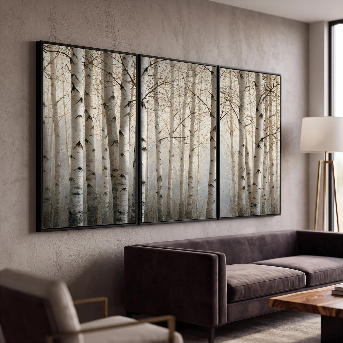 Pale birch trunks and delicate bare branches in a soft neutral woodland 3 piece framed canvas wall art displayed in a modern living room