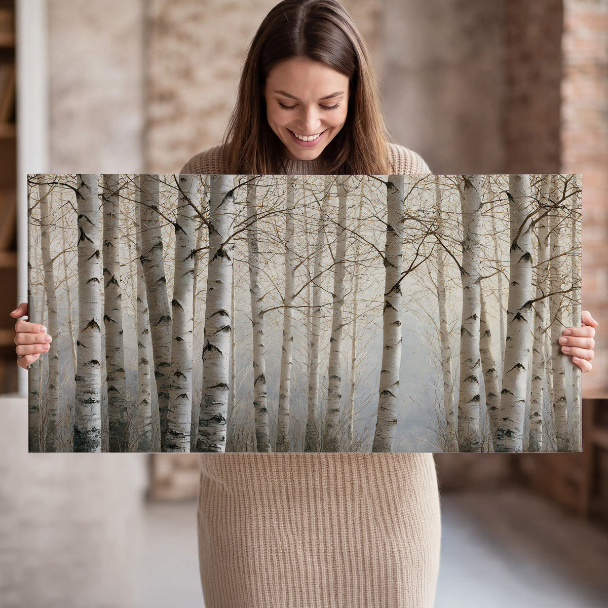 Pale birch trunks and delicate bare branches in a soft neutral woodland single canvas wall art held in hands