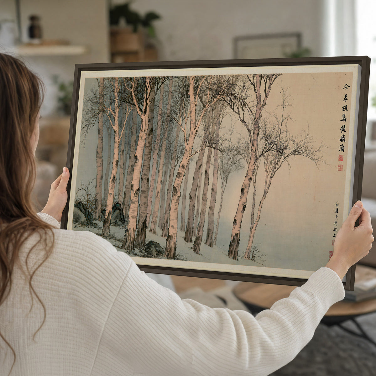 Slender pale birches in a muted woodland scene with decorative script single framed canvas wall art held in hands