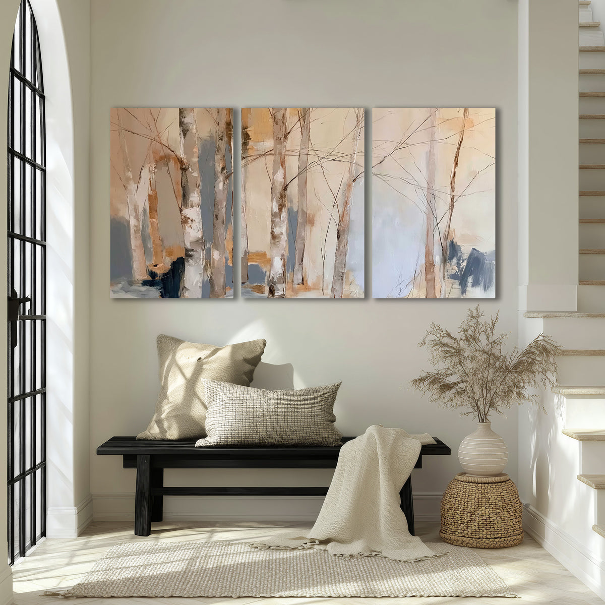 Loose pale blue, peach and cream strokes suggesting a stand of birch trees 3 piece canvas wall art displayed in a entryway