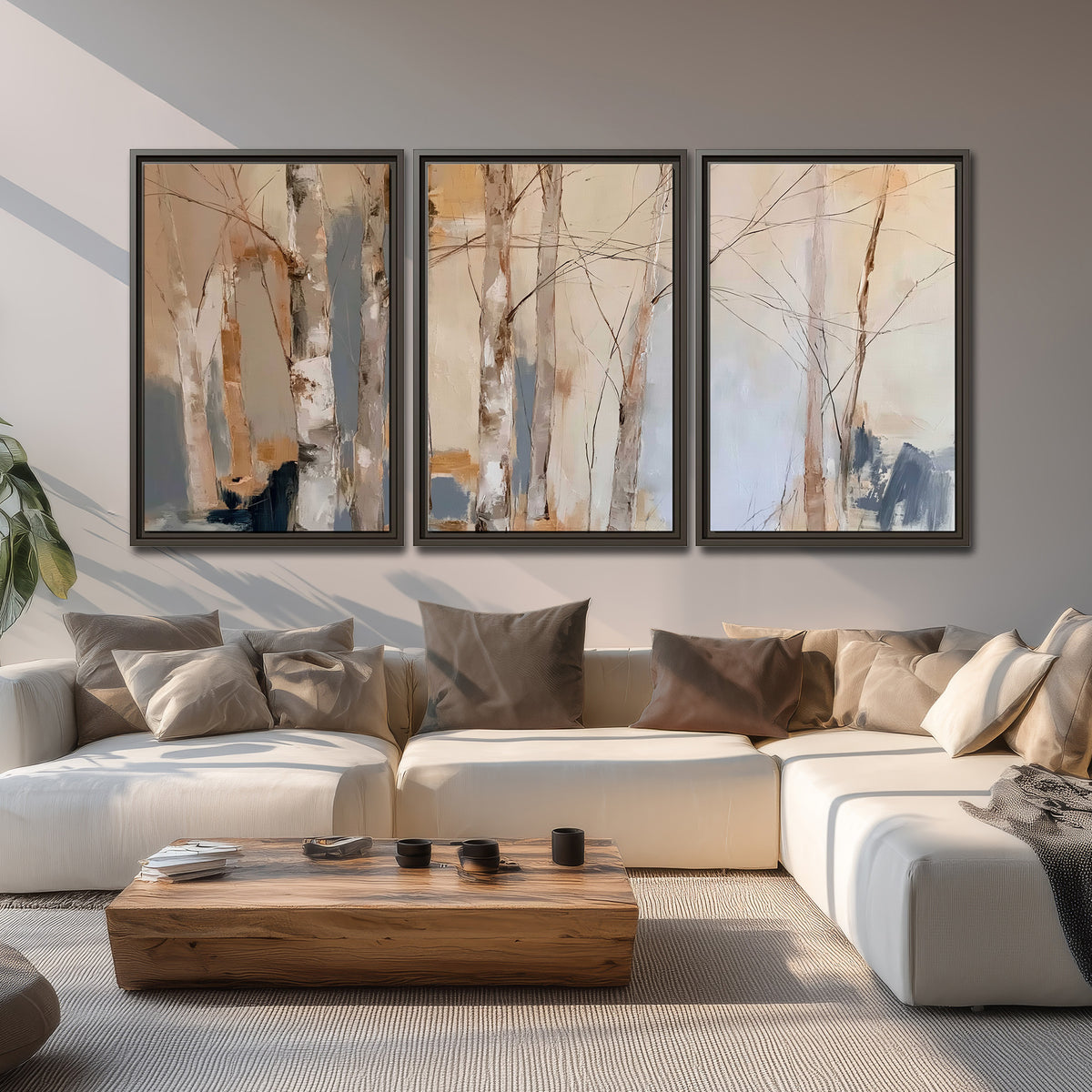 Loose pale blue, peach and cream strokes suggesting a stand of birch trees 3 piece framed canvas wall art displayed in a living room