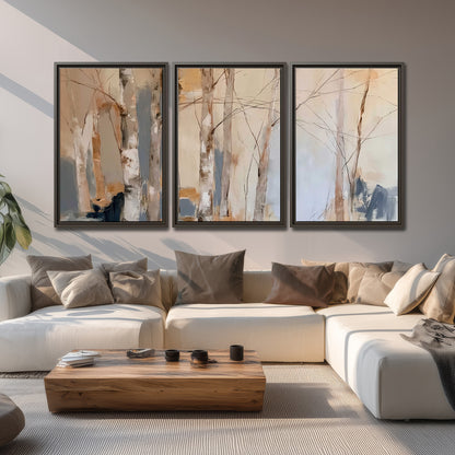 Loose pale blue, peach and cream strokes suggesting a stand of birch trees 3 piece framed canvas wall art displayed in a living room