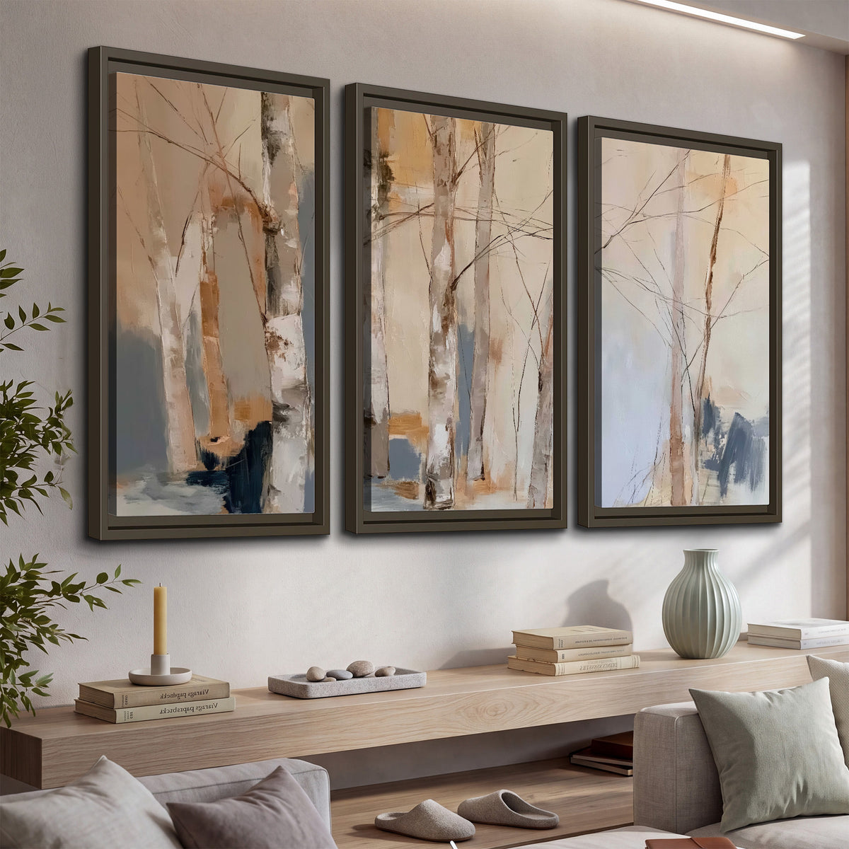 Loose pale blue, peach and cream strokes suggesting a stand of birch trees 3 piece framed canvas wall art displayed in a console