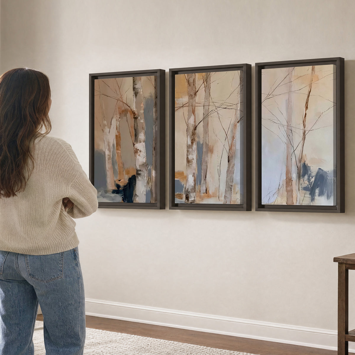 Loose pale blue, peach and cream strokes suggesting a stand of birch trees 3 piece framed canvas wall art three panel arrangement on a wall