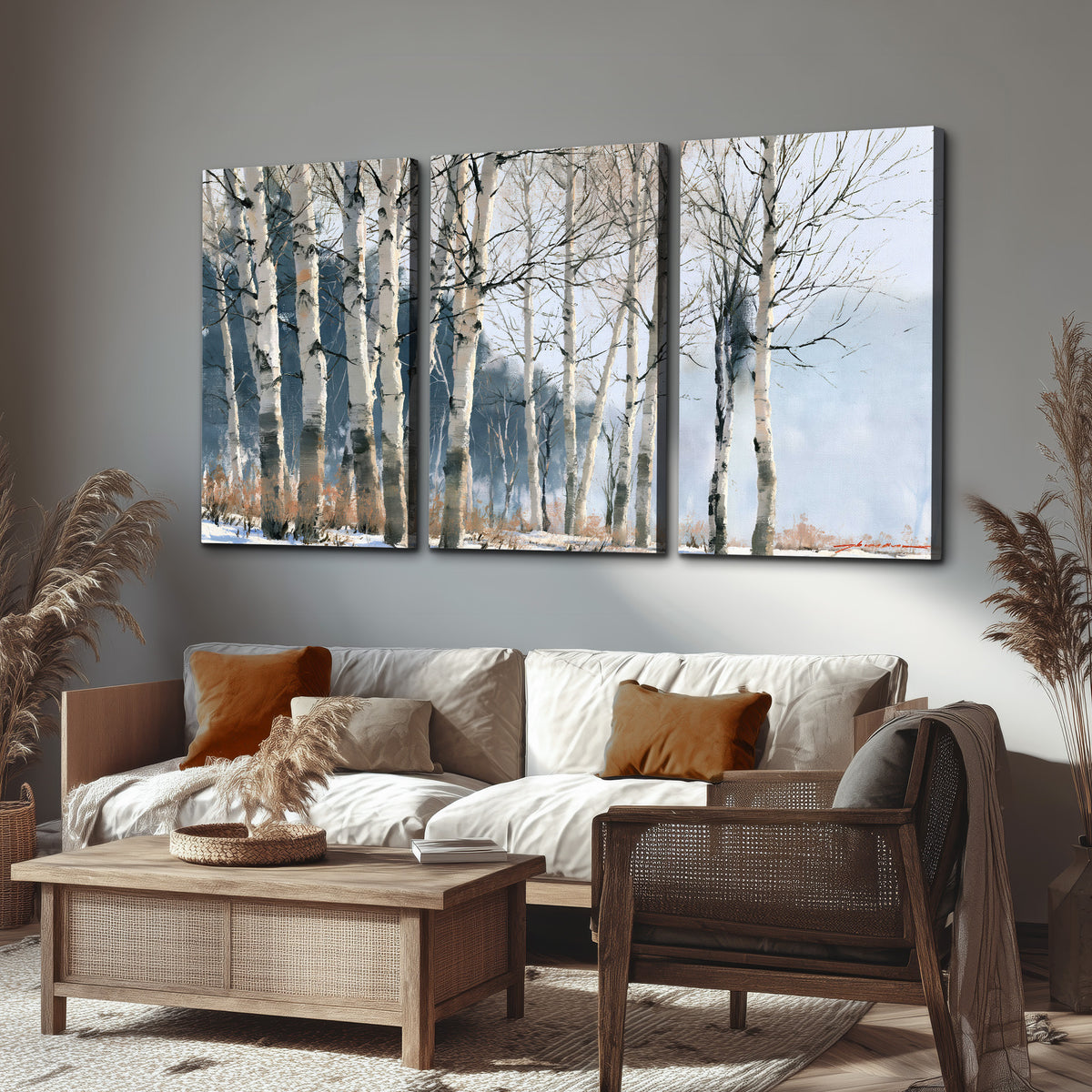 A line of bare birch trees against a cool blue-gray sky 3 piece canvas wall art displayed in a rustic living room