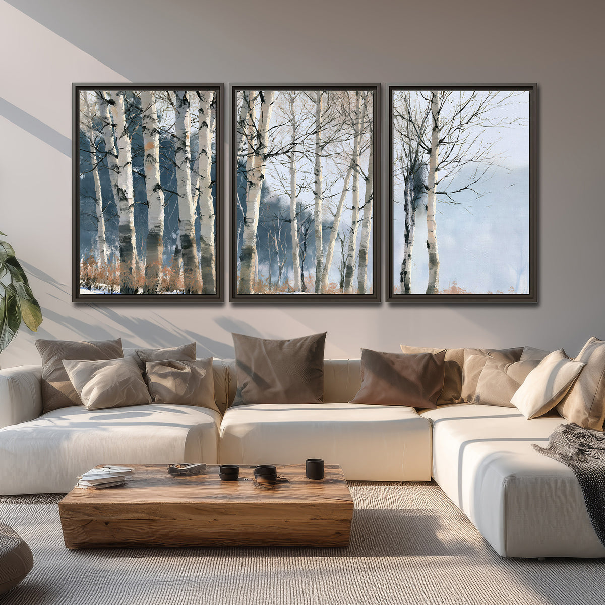 A line of bare birch trees against a cool blue-gray sky 3 piece framed canvas wall art displayed in a living room