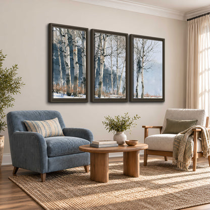 A line of bare birch trees against a cool blue-gray sky 3 piece framed canvas wall art styled in an interior