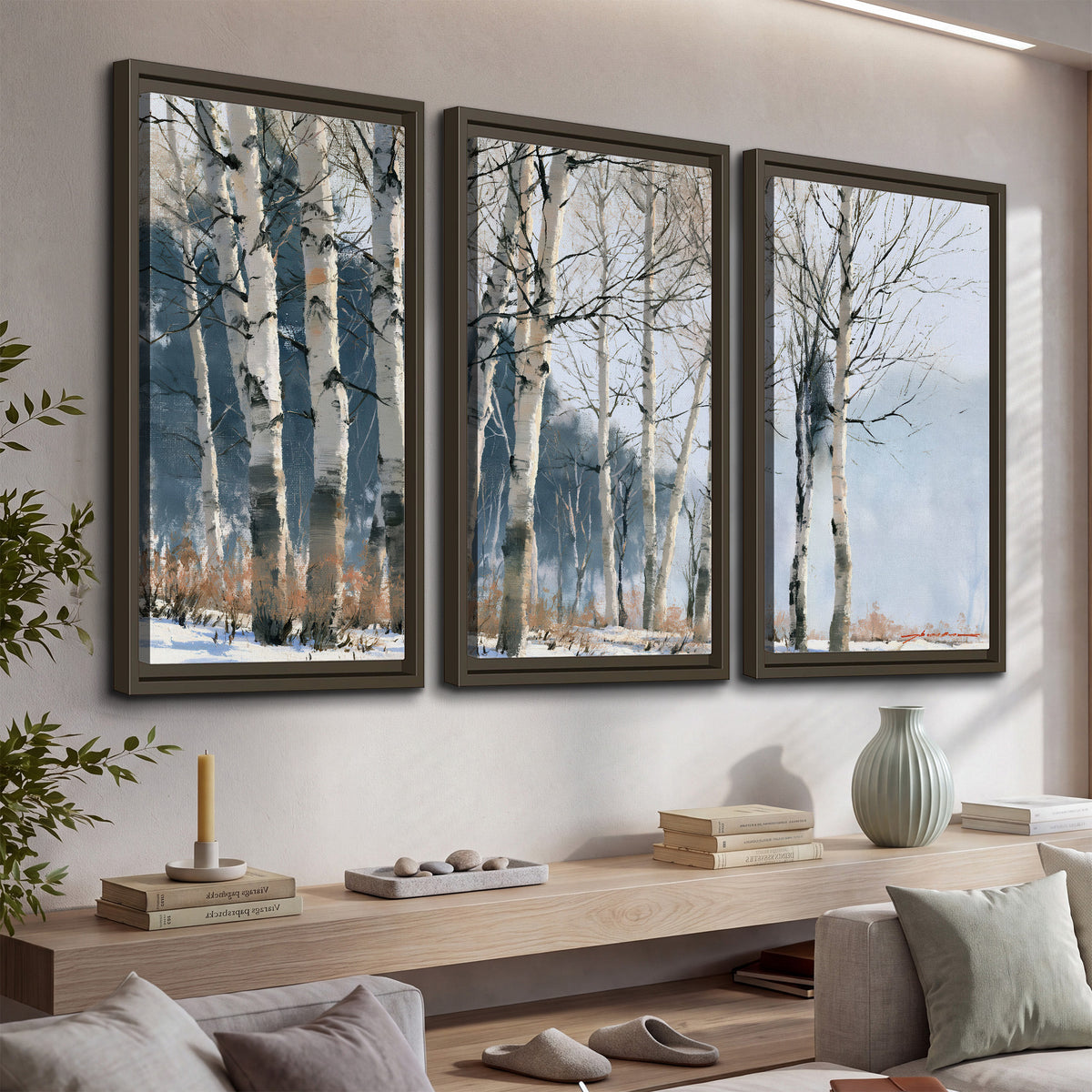 A line of bare birch trees against a cool blue-gray sky 3 piece framed canvas wall art displayed in a console