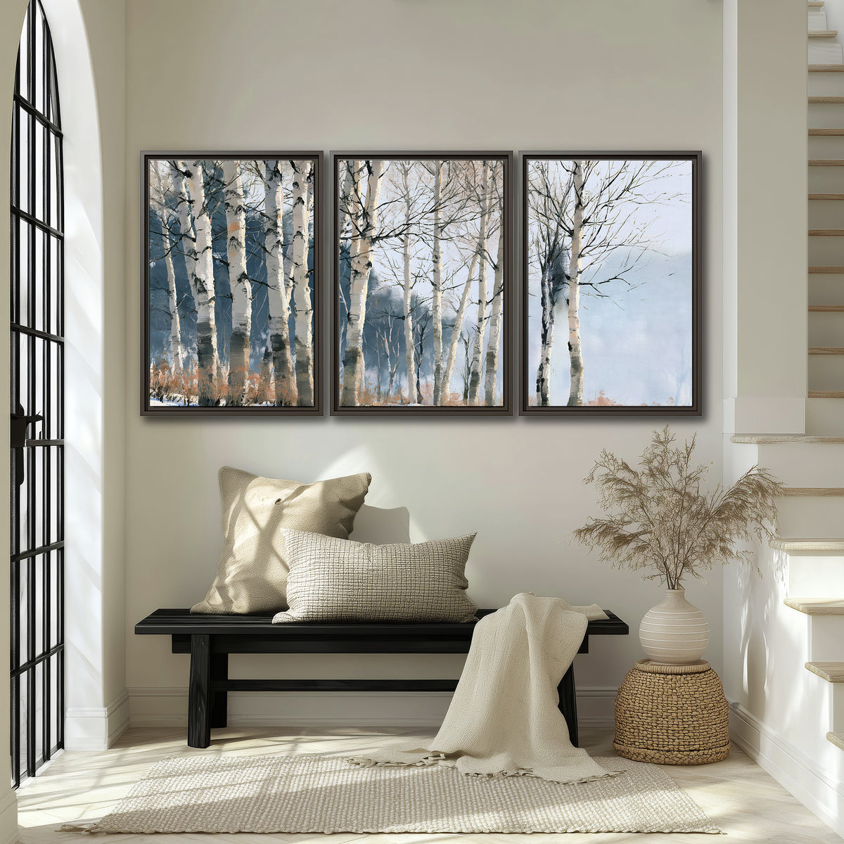 A line of bare birch trees against a cool blue-gray sky 3 piece framed canvas wall art displayed in a entryway