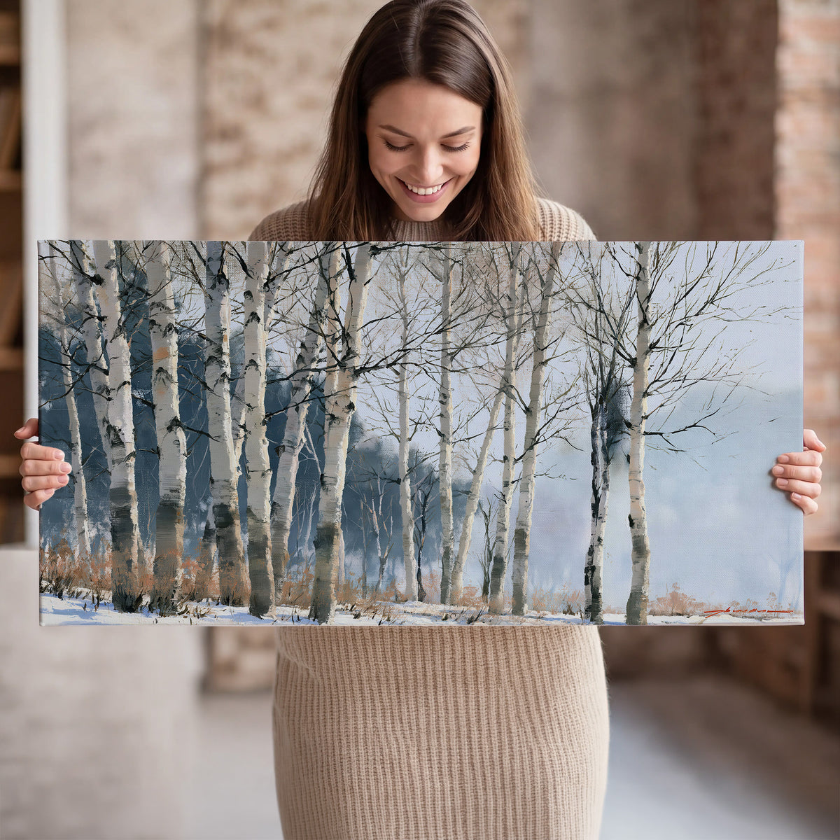 A line of bare birch trees against a cool blue-gray sky single canvas wall art held in hands