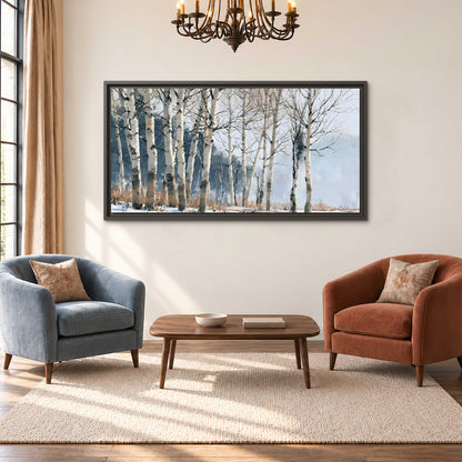 A line of bare birch trees against a cool blue-gray sky single framed canvas wall art styled in an interior