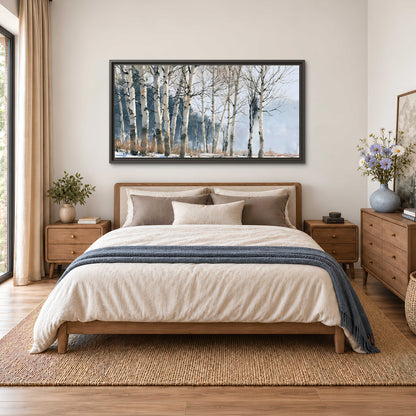 A line of bare birch trees against a cool blue-gray sky single framed canvas wall art styled in an interior