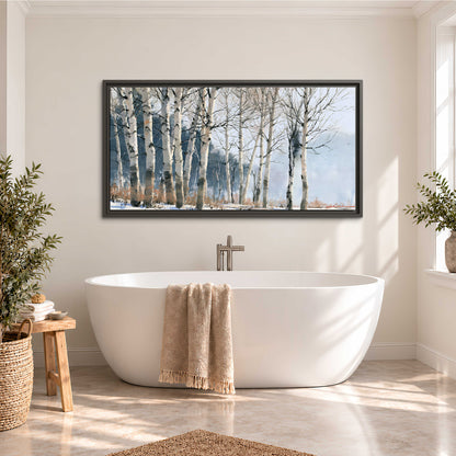 A line of bare birch trees against a cool blue-gray sky single framed canvas wall art styled in an interior