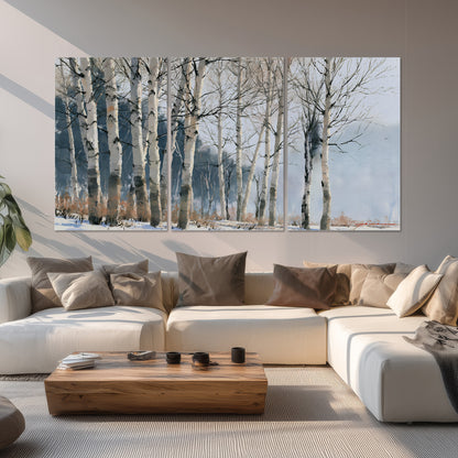 A line of bare birch trees against a cool blue-gray sky set of 3 poster prints displayed in a living room