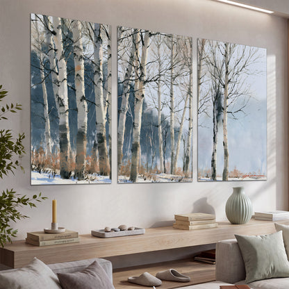 A line of bare birch trees against a cool blue-gray sky set of 3 poster prints displayed in a console