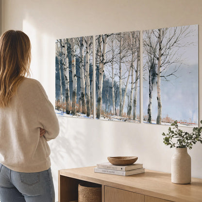 A line of bare birch trees against a cool blue-gray sky set of 3 poster prints three panel arrangement on a wall