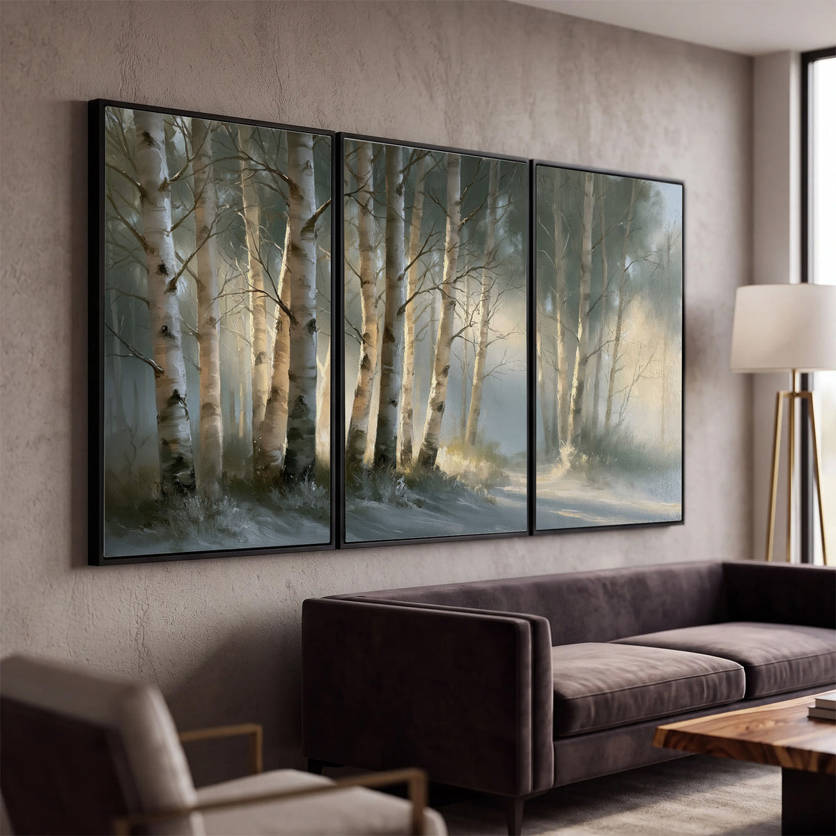A softly lit woodland path winding between pale birch trunks 3 piece framed canvas wall art displayed in a modern living room