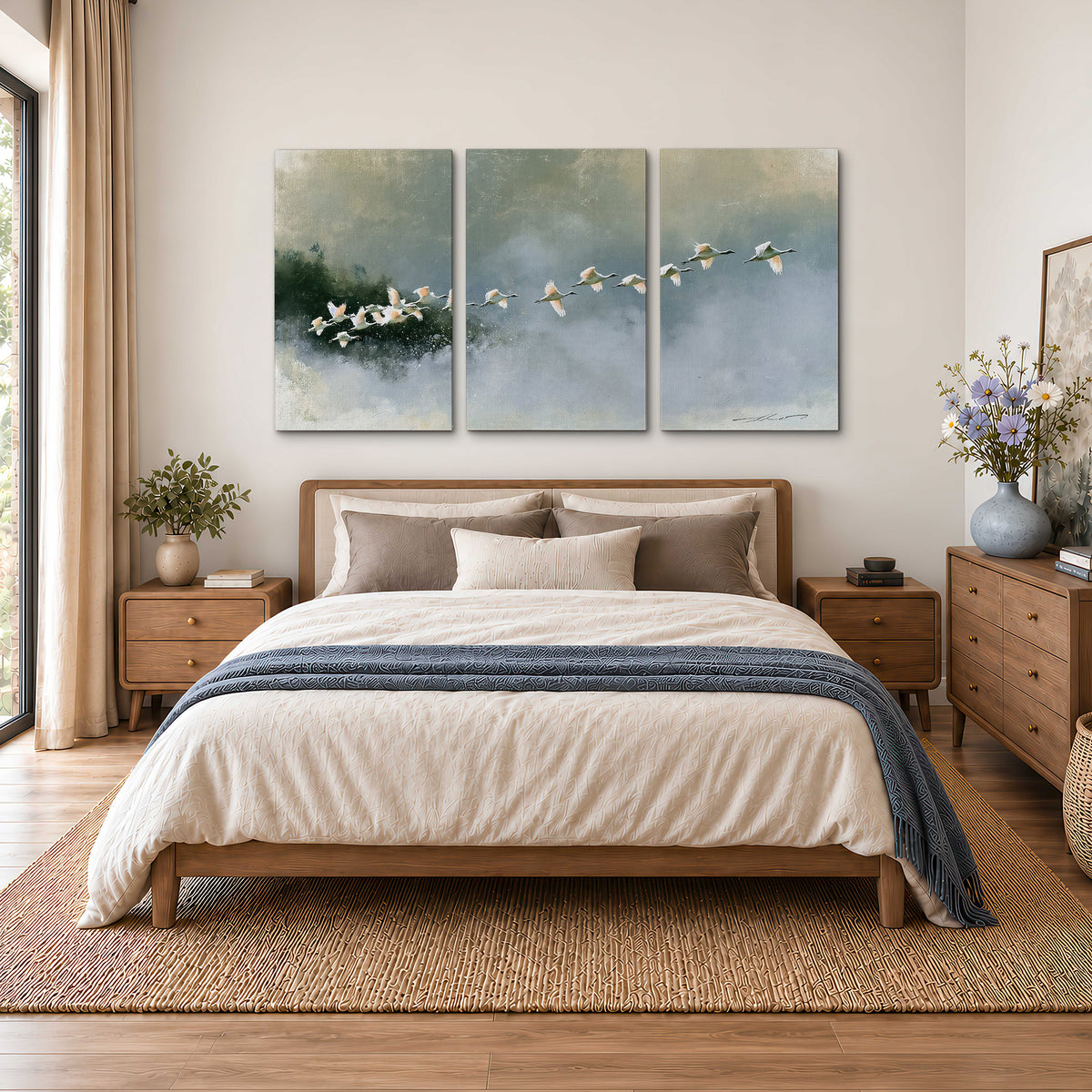 A flock of white birds flying low above a quiet blue-green lake 3 piece canvas wall art styled in an interior