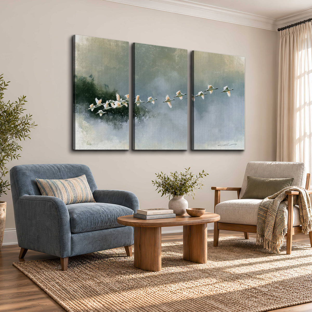 A flock of white birds flying low above a quiet blue-green lake 3 piece canvas wall art styled in an interior