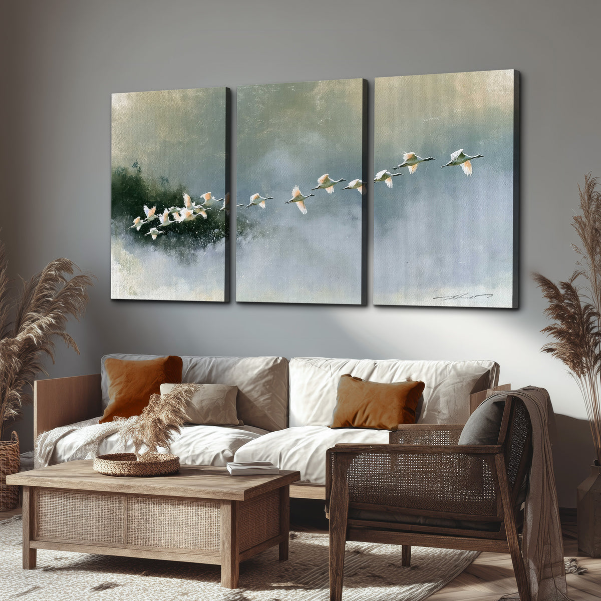 A flock of white birds flying low above a quiet blue-green lake 3 piece canvas wall art displayed in a rustic living room