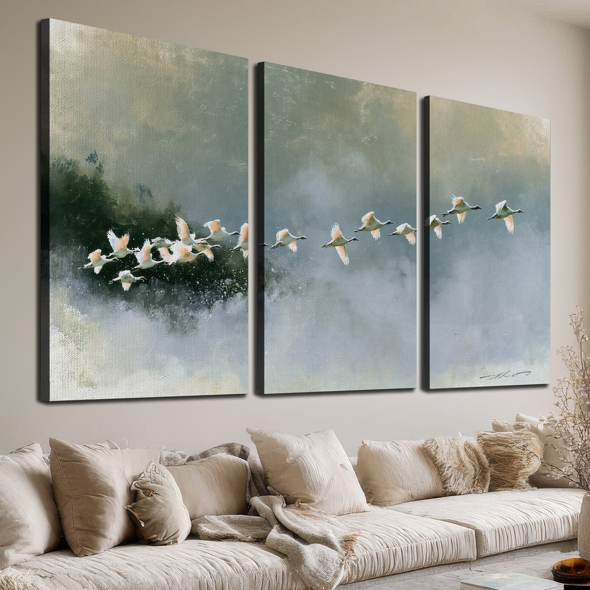 A flock of white birds flying low above a quiet blue-green lake 3 piece canvas wall art room and product view