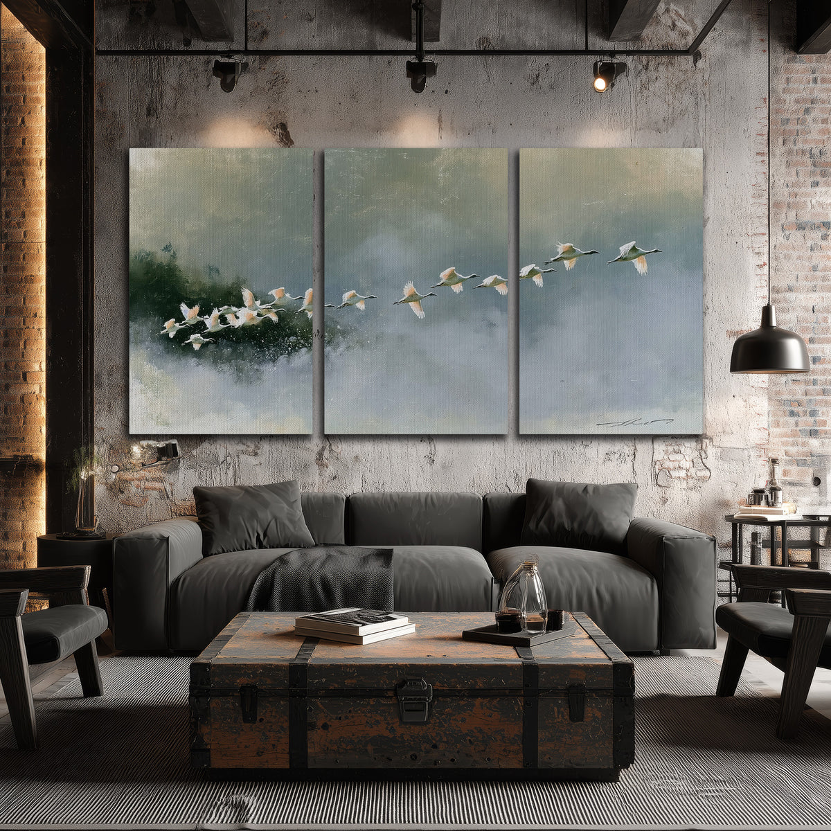 A flock of white birds flying low above a quiet blue-green lake 3 piece canvas wall art displayed in a industrial room