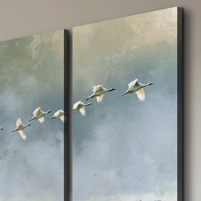 A flock of white birds flying low above a quiet blue-green lake 3 piece canvas wall art room and product view