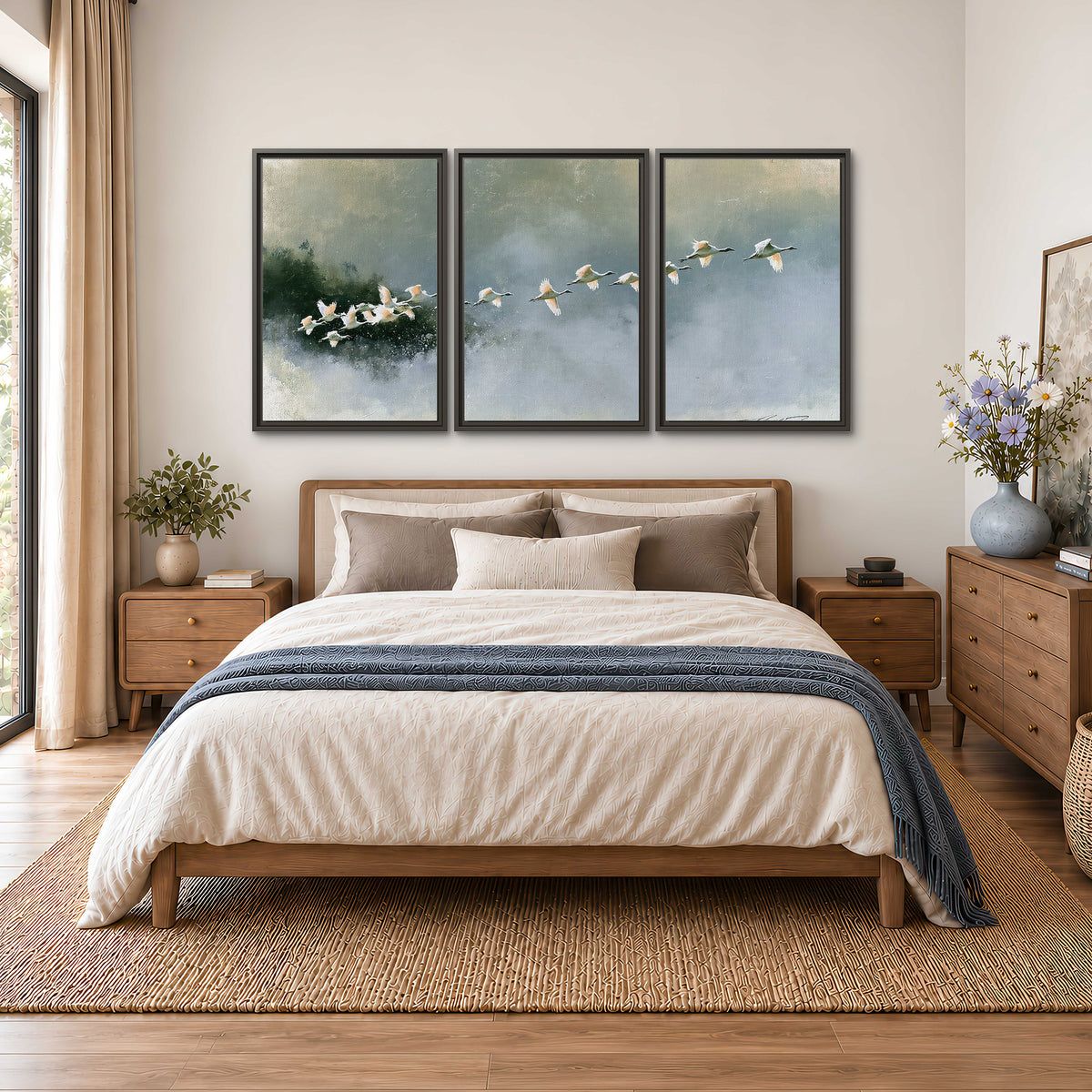 A flock of white birds flying low above a quiet blue-green lake 3 piece framed canvas wall art styled in an interior