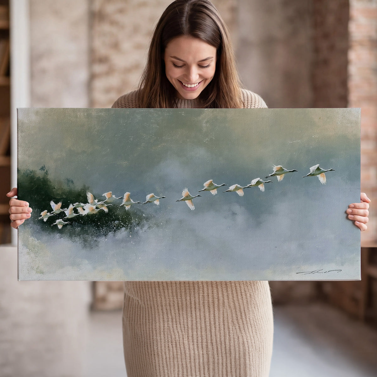 A flock of white birds flying low above a quiet blue-green lake single canvas wall art held in hands