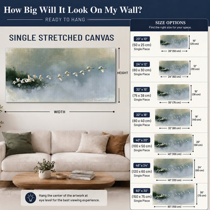 A flock of white birds flying low above a quiet blue-green lake single canvas wall art size guide above a sofa; room view is illustrative