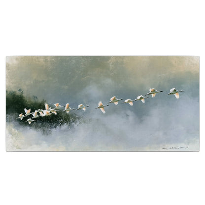 A flock of white birds flying low above a quiet blue-green lake single canvas wall art viewed straight on