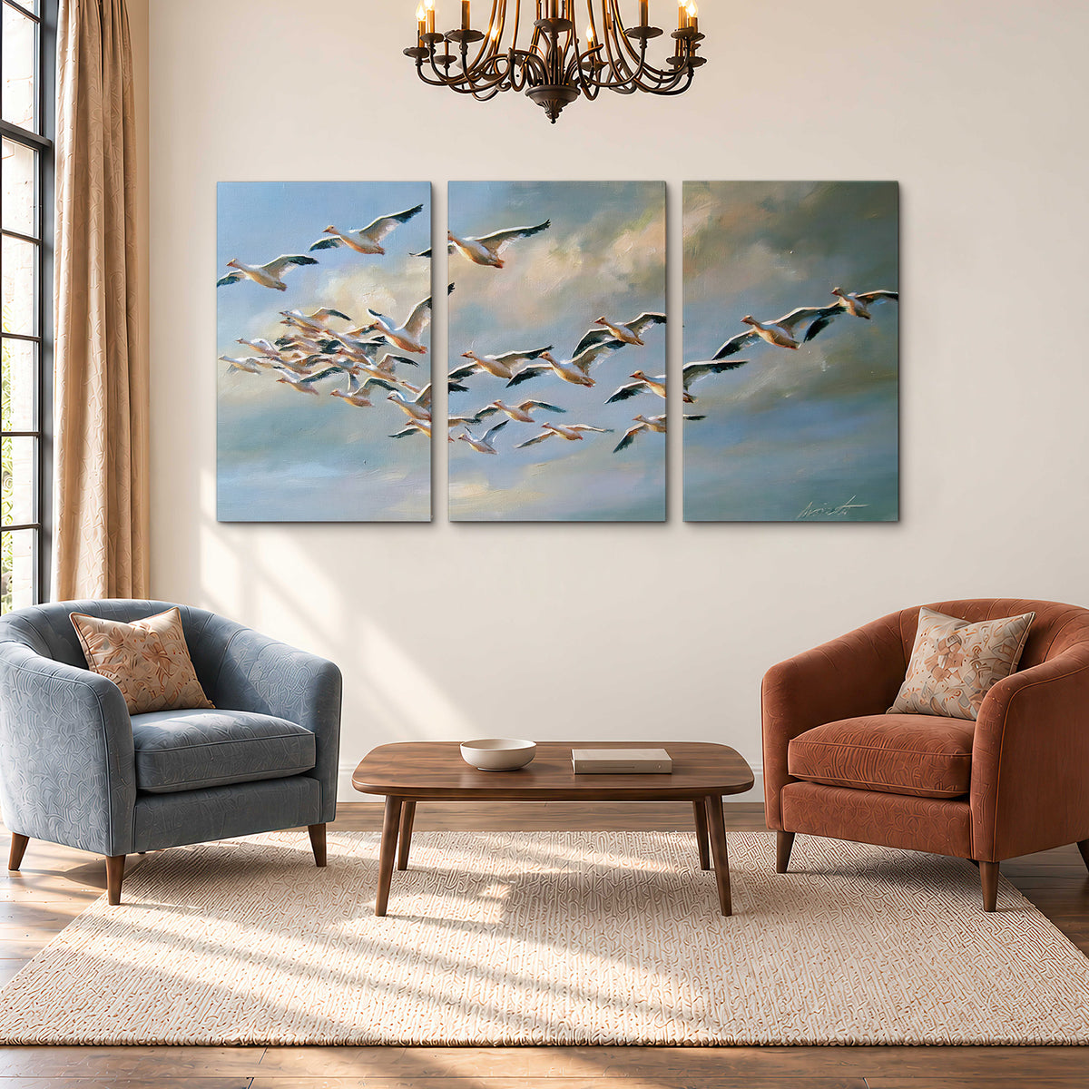 A flock of pale seabirds gliding beneath soft clouds across a blue sky 3 piece canvas wall art styled in an interior