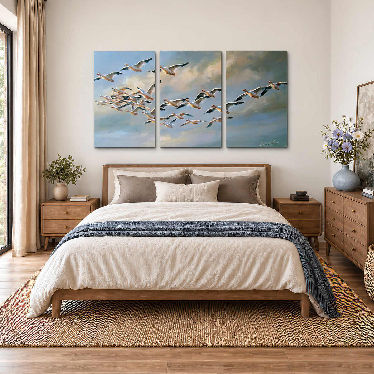 A flock of pale seabirds gliding beneath soft clouds across a blue sky 3 piece canvas wall art styled in an interior