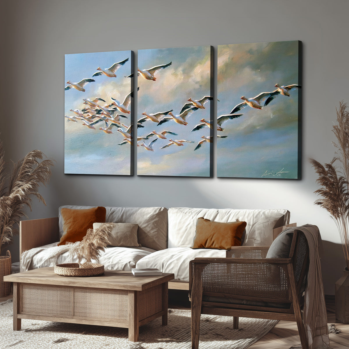 A flock of pale seabirds gliding beneath soft clouds across a blue sky 3 piece canvas wall art displayed in a rustic living room