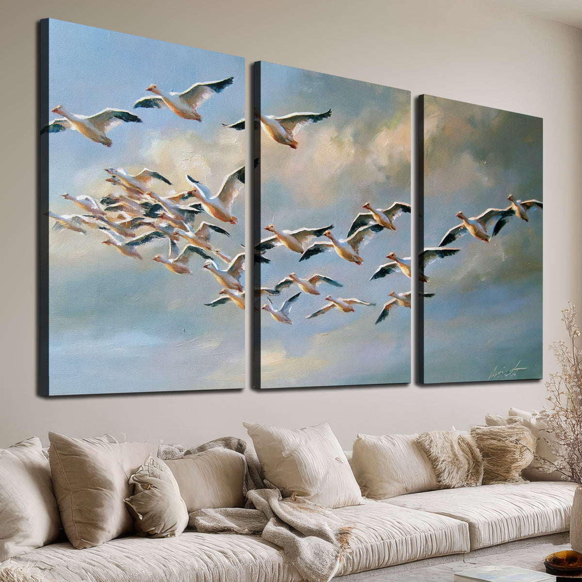 A flock of pale seabirds gliding beneath soft clouds across a blue sky 3 piece canvas wall art room and product view