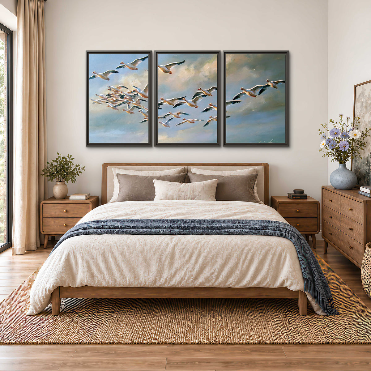 A flock of pale seabirds gliding beneath soft clouds across a blue sky 3 piece framed canvas wall art styled in an interior