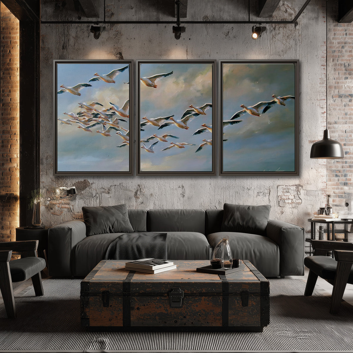 A flock of pale seabirds gliding beneath soft clouds across a blue sky 3 piece framed canvas wall art displayed in a industrial room