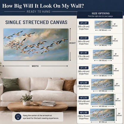 A flock of pale seabirds gliding beneath soft clouds across a blue sky single canvas wall art size guide above a sofa; room view is illustrative