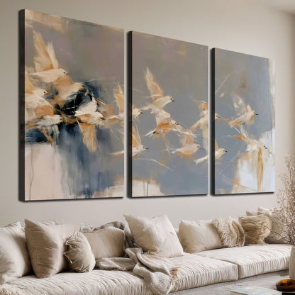 Pale bird-like forms sweeping across layered strokes of blue, ochre and cream 3 piece canvas wall art room and product view