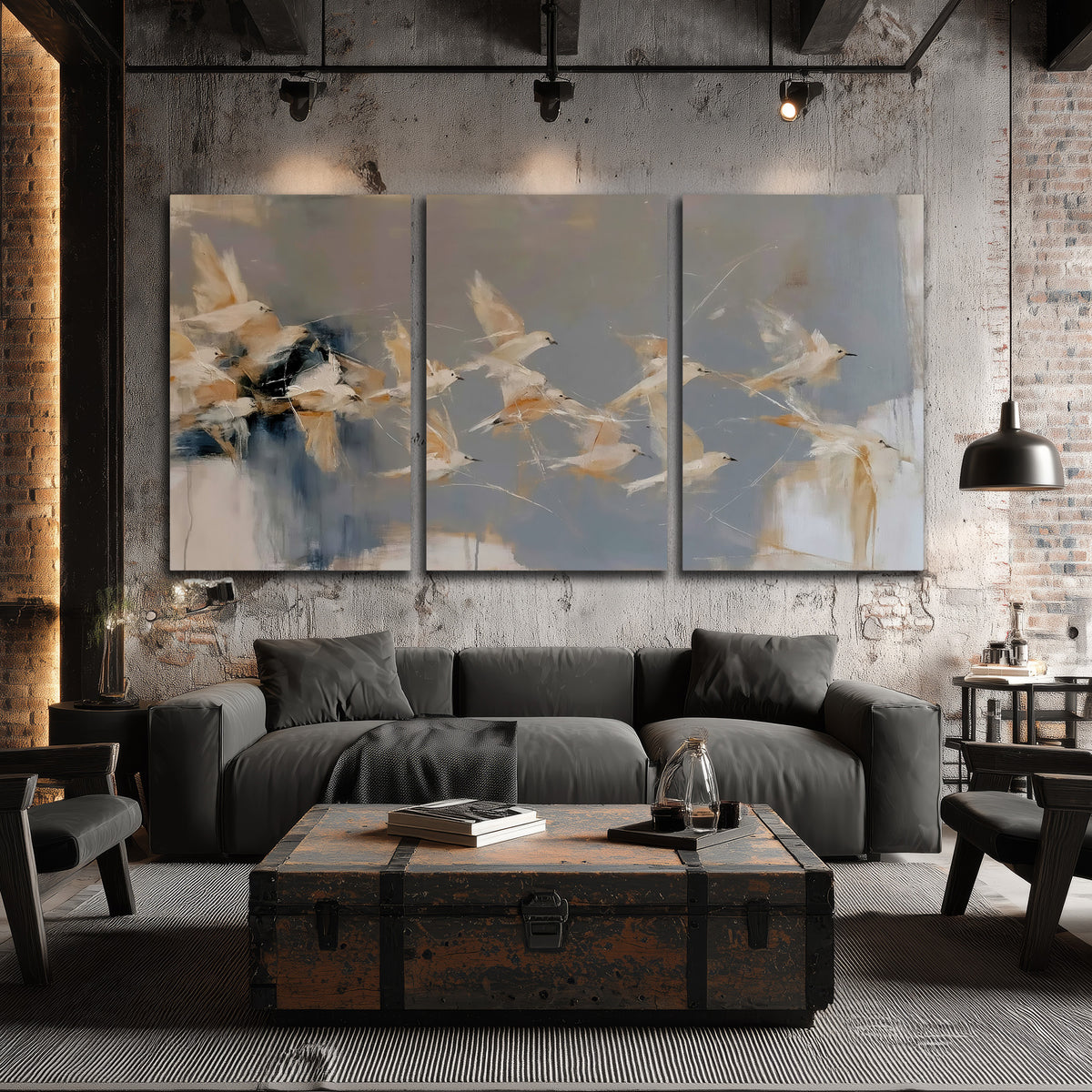Pale bird-like forms sweeping across layered strokes of blue, ochre and cream 3 piece canvas wall art displayed in a industrial room