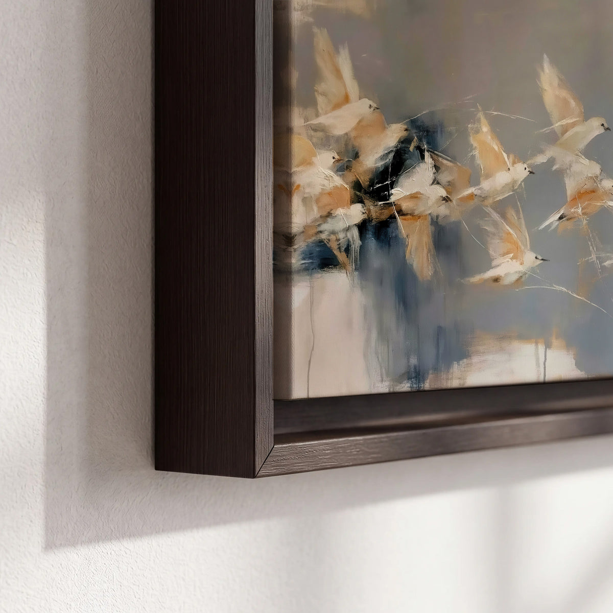 Pale bird-like forms sweeping across layered strokes of blue, ochre and cream 3 piece framed canvas wall art material and edge close up