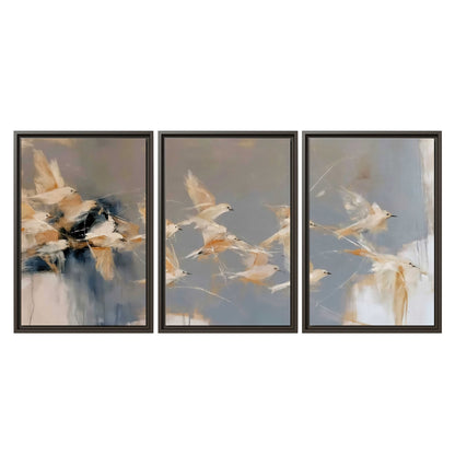 Pale bird-like forms sweeping across layered strokes of blue, ochre and cream 3 piece framed canvas wall art viewed straight on