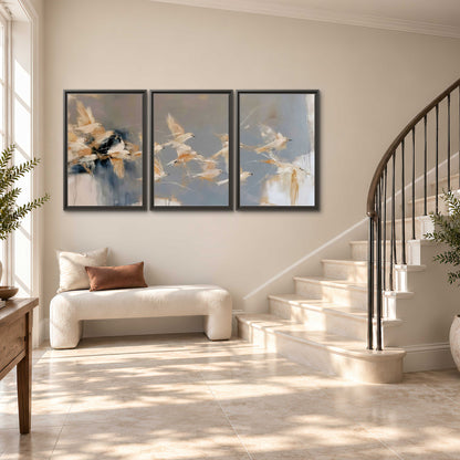 Pale bird-like forms sweeping across layered strokes of blue, ochre and cream 3 piece framed canvas wall art styled in an interior