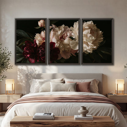 Full ivory and deep burgundy peonies against a dark green background 3 piece framed canvas wall art displayed in a bedroom
