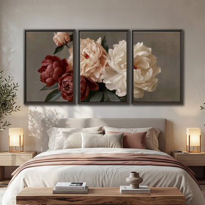 Large blush peonies and rust-colored flowers in a softly shaded arrangement 3 piece framed canvas wall art displayed in a bedroom